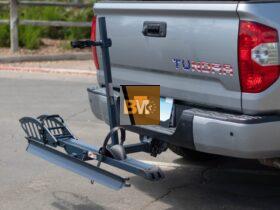 An eBike securely mounted on a rear hitch rack positioned on a car.